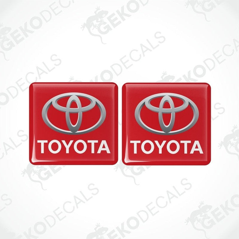 Two red vinyl stickers with the Toyota logo in red and white.