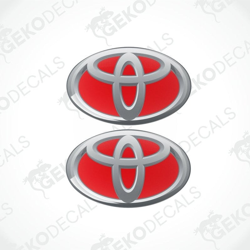 Two Toyota branded vinyl stickers with a dome shape and a silver and red color scheme.