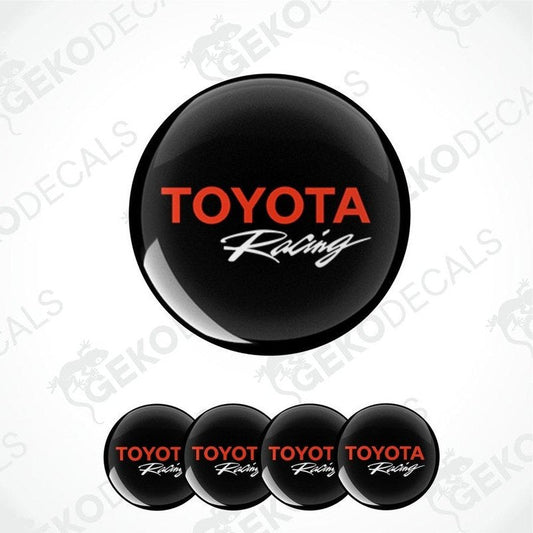 A set of four black vinyl decals with the red text 'TOYOTA Racing' on them, displayed against a white background.
