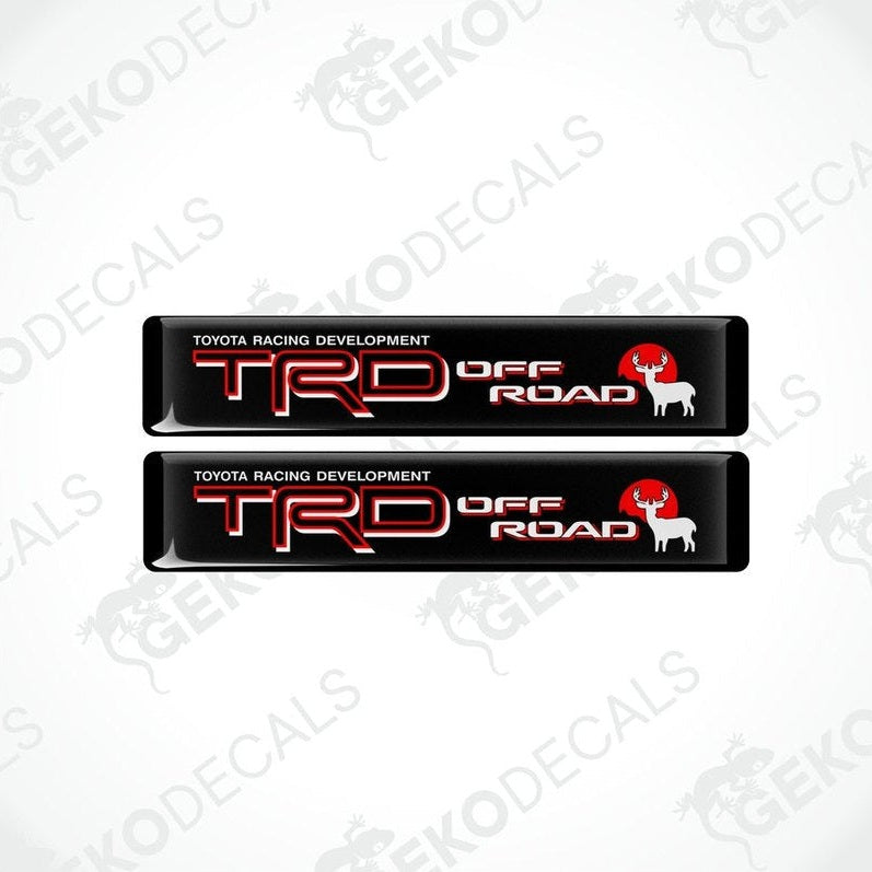 Two black vinyl decals with red and white text that read 'TOYOTA RACING DEVELOPMENT TRD OFF ROAD'.