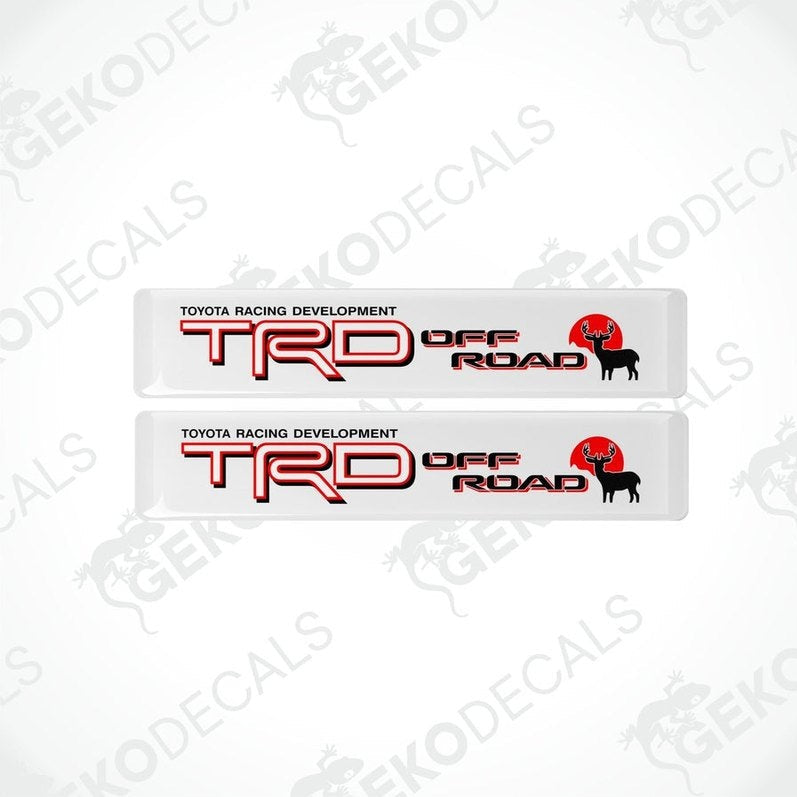 Two withe vinyl decals with red and black text that read 'TOYOTA RACING DEVELOPMENT TRD OFF ROAD'.