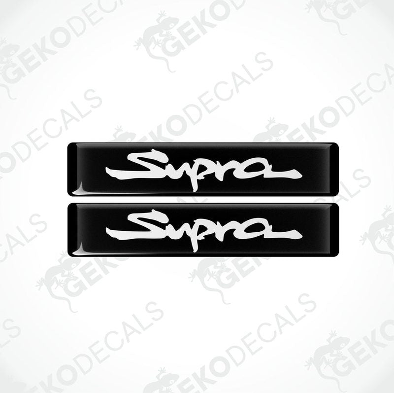 Two black vinyl stickers with the word 'SUPRA' written in white.