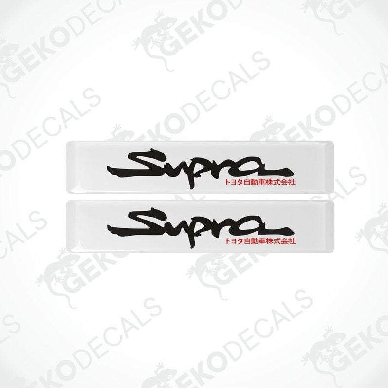 Two withe vinyl stickers with the word 'SUPRA' written in black.