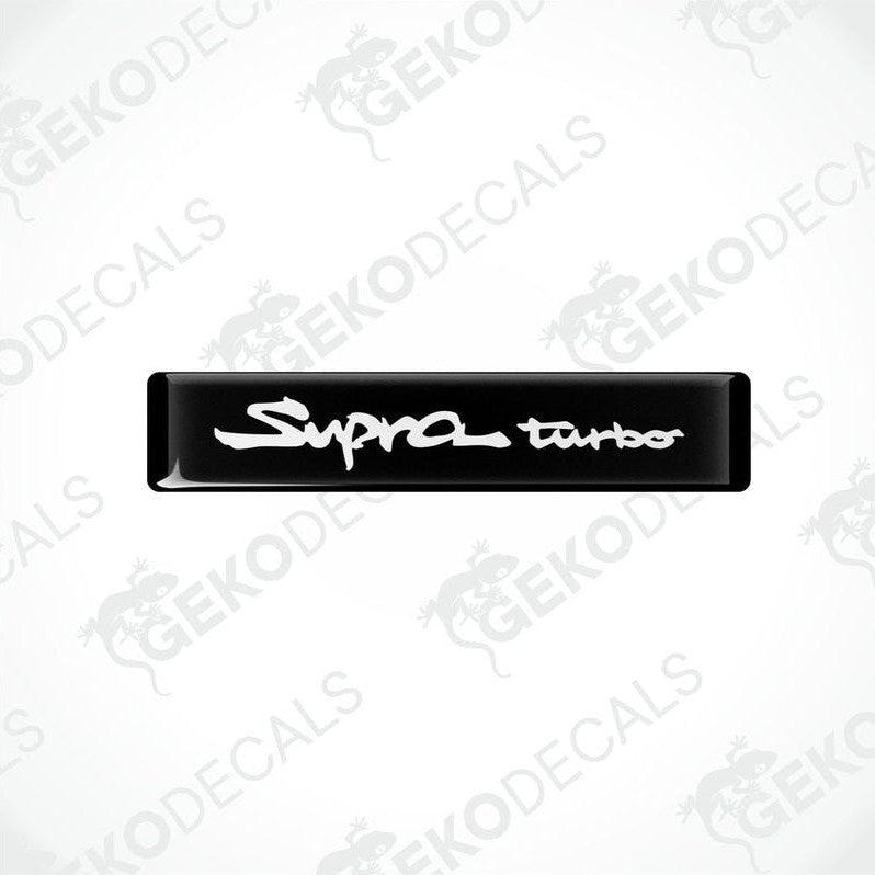 Black vinyl decals with 'Supra turbo' text in white, indicating a set of car stickers for a Toyota Supra vehicle.