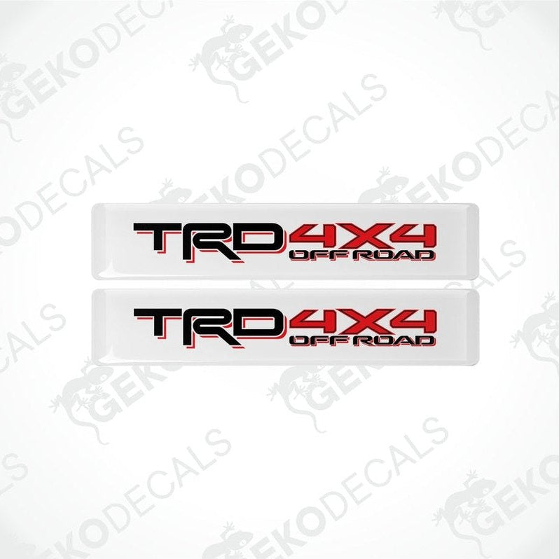 Two withe decals with red and black text that reads 'TRD 4X4 OFF ROAD'.