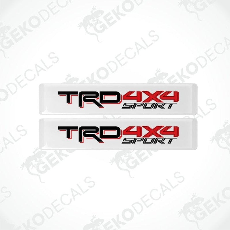 Two withe decals with red and black text that reads 'TRD 4X4 OFF ROAD'.
