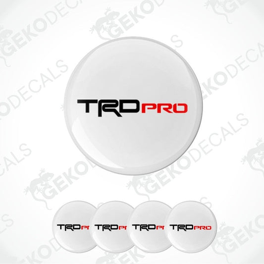 A set of four white vinyl decals with the TRD PRO logo, designed for use on vehicles.