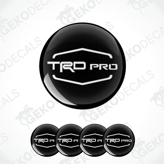 A set of four black vinyl stickers with the 'TOYOTA TRD PRO' logo, designed for use as car decals.