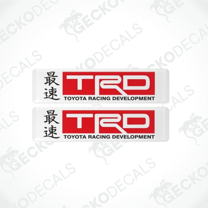 two red and black Toyota Racing Development logos on a white background with hieroglyphs in front