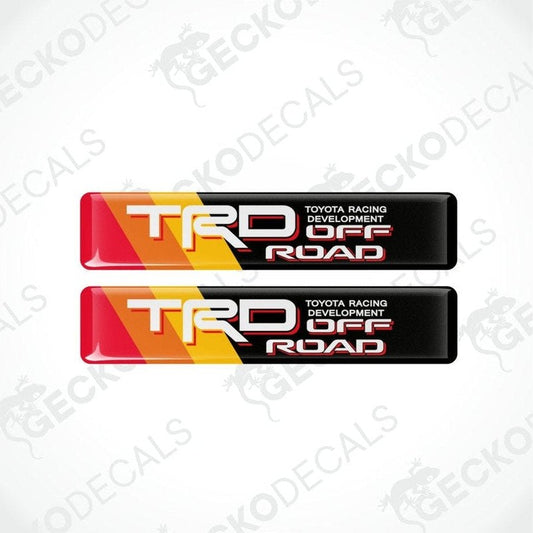 two rectangles, background with diagonal stripes of red, orange, yellow and black, with the TRD Off-Road logo in white in the middle