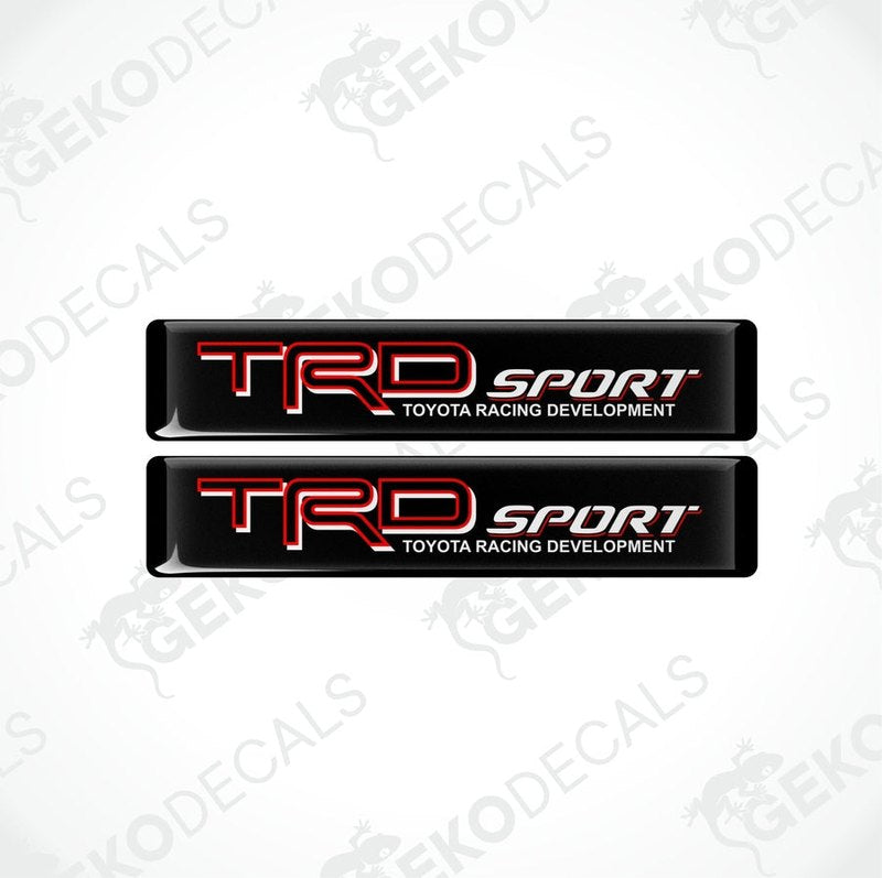 Two black vinyl stickers with red and white text, including the Toyota Racing Development logo.