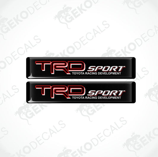 Two black vinyl stickers with red and white text, including the Toyota Racing Development logo.