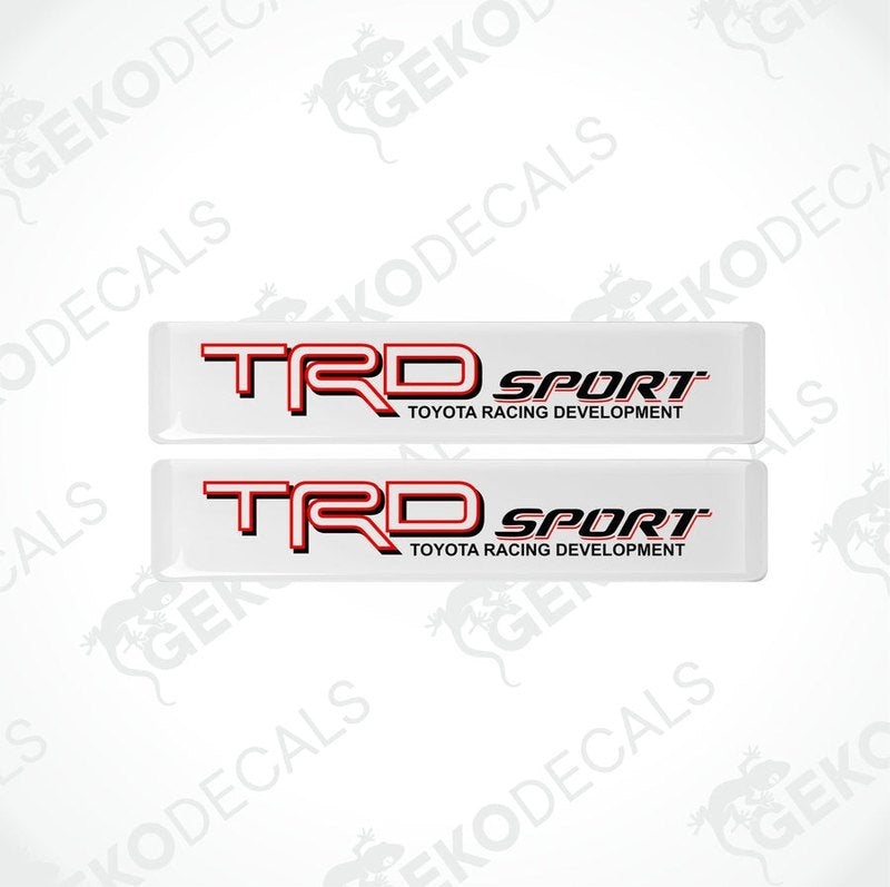 Two withe vinyl stickers with red and black text, including the Toyota Racing Development logo.