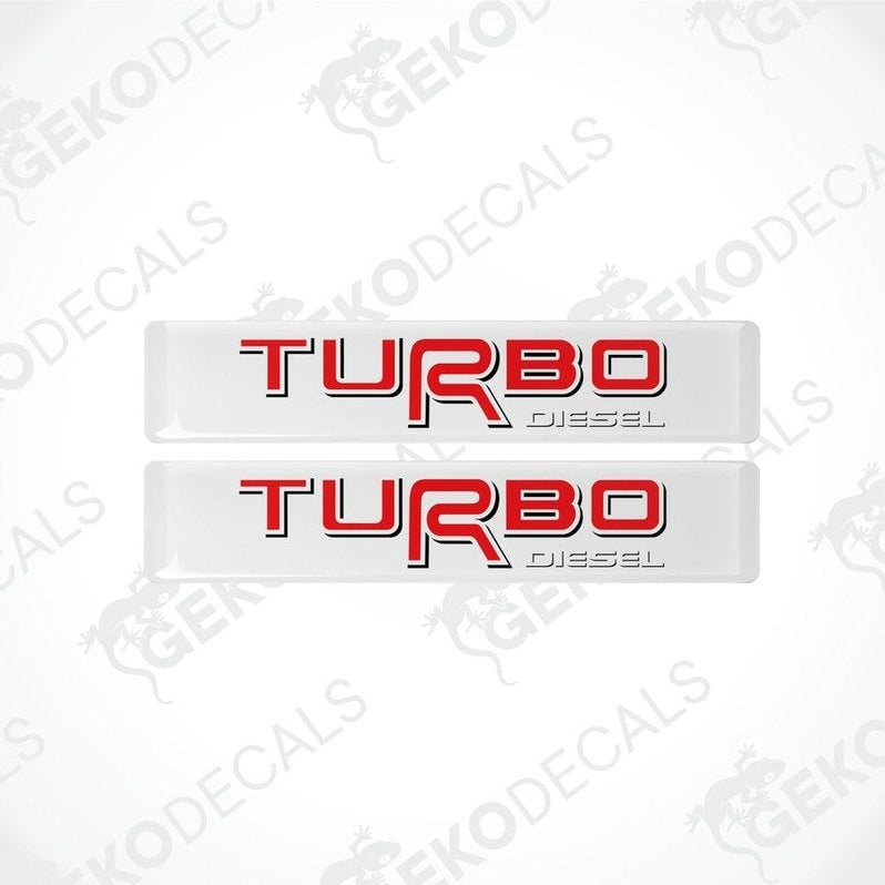 Two withe vinyl stickers with the text 'TOYOTA TURBO DIESEL' in red and black.