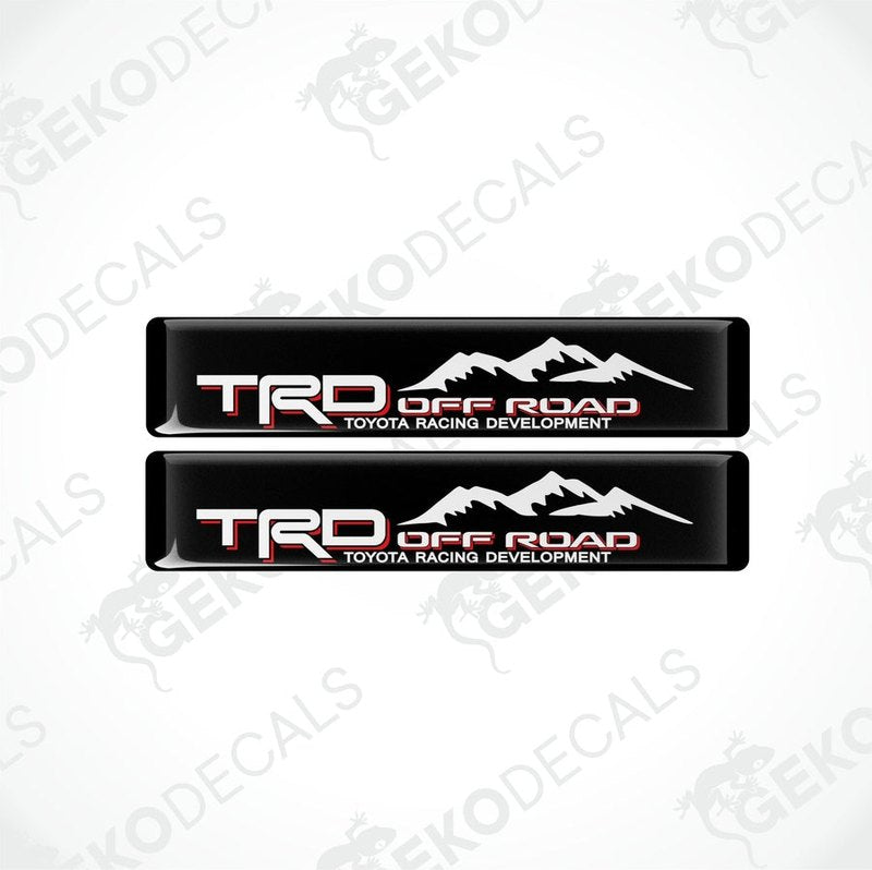 Two black vinyl stickers with red and white text, featuring the Toyota Racing Development logo.