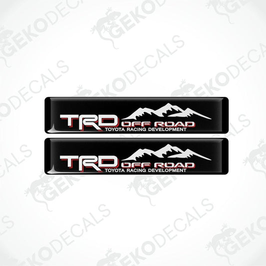 Two black vinyl stickers with red and white text, featuring the Toyota Racing Development logo.
