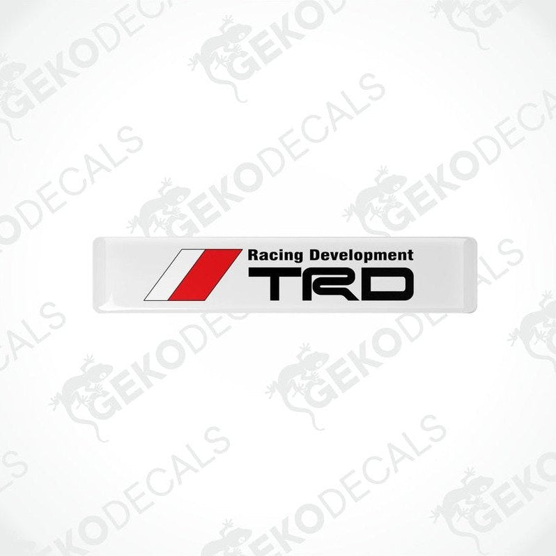  Withe, red, and black vinyl decals with the text 'Racing Development TRD' on them.