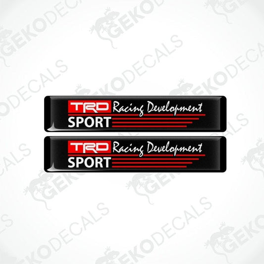 Two black vinyl stickers with red and white text that reads 'TRD RACING DEVELOPMENT SPORT'. There are two Gecko Decals logos, one at the top and one at the bottom, with a watermark that says 'GECKODECALS'.