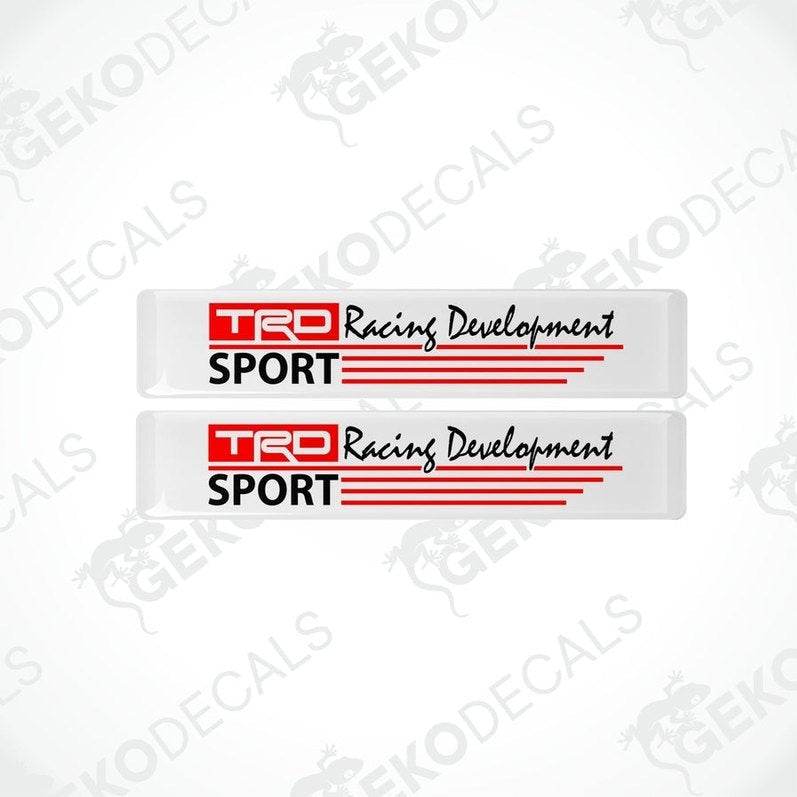 Two withe vinyl stickers with red and blacktext that reads 'TRD RACING DEVELOPMENT SPORT'. There are two Gecko Decals logos, one at the top and one at the bottom, with a watermark that says 'GECKODECALS'.
