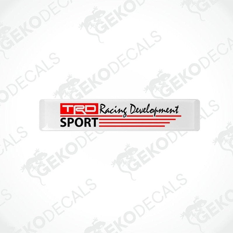 Withe vinyl stickers with red and blacktext that reads 'TRD RACING DEVELOPMENT SPORT'. There are two Gecko Decals logos, one at the top and one at the bottom, with a watermark that says 'GECKODECALS'.