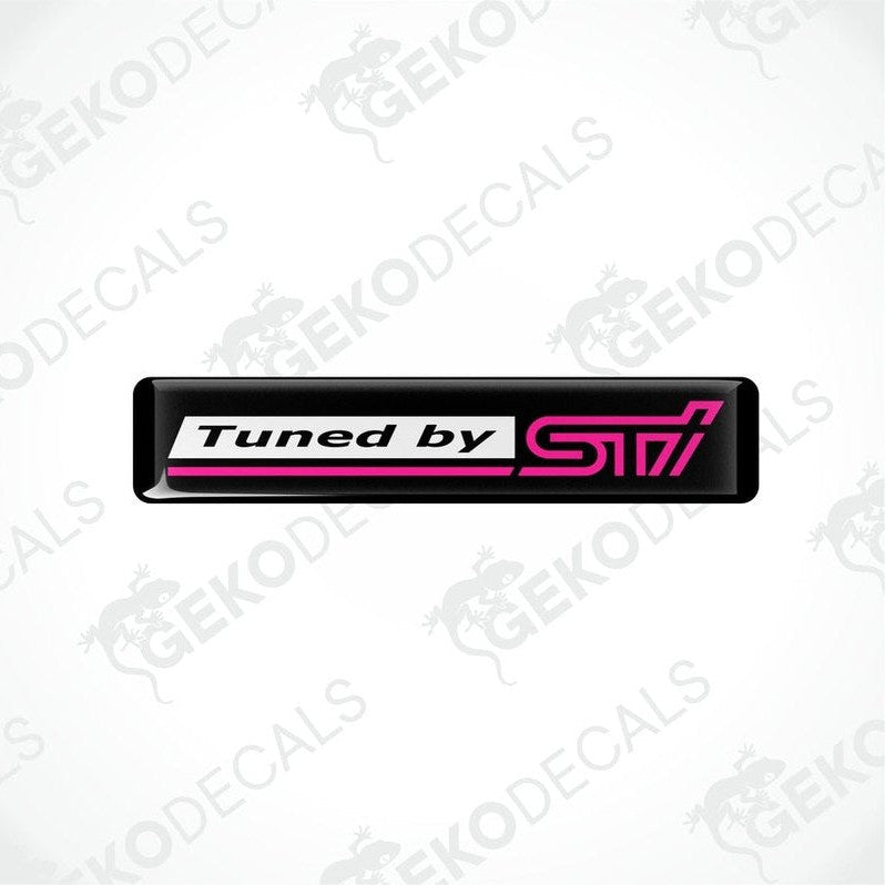 Rectangular vinyl decals with a polyurethane coating, black with pink text, featuring the 'Tuned by STI' logo.