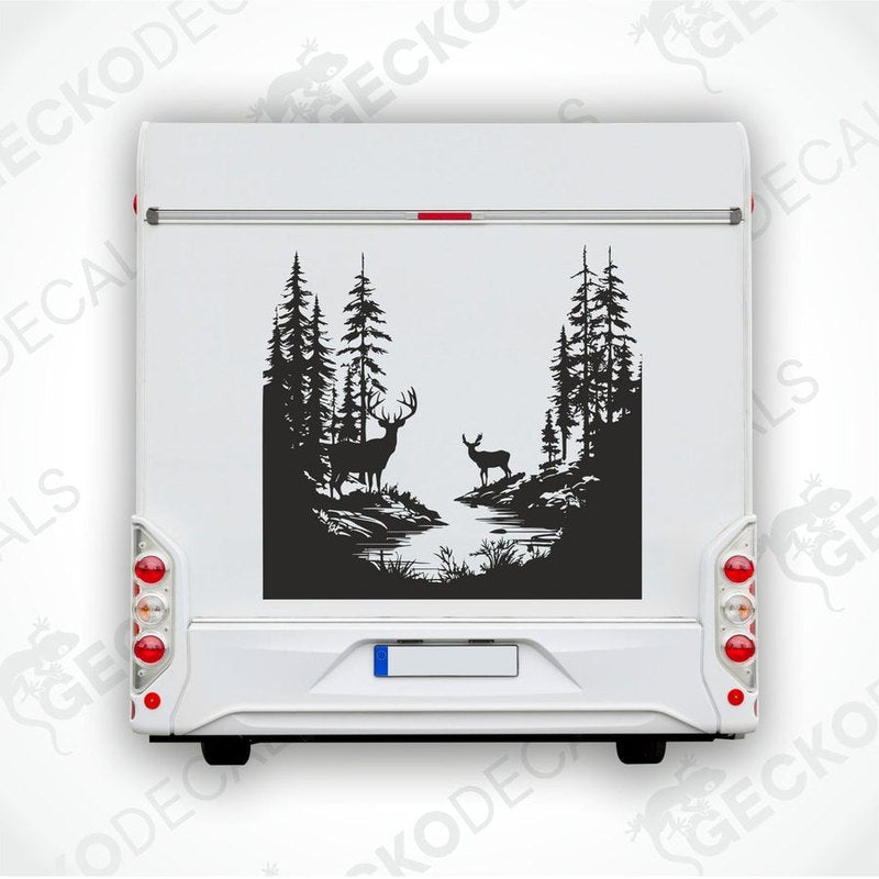 A die cut decal of two deer in a forest setting, intended for use on vehicles or other surfaces.