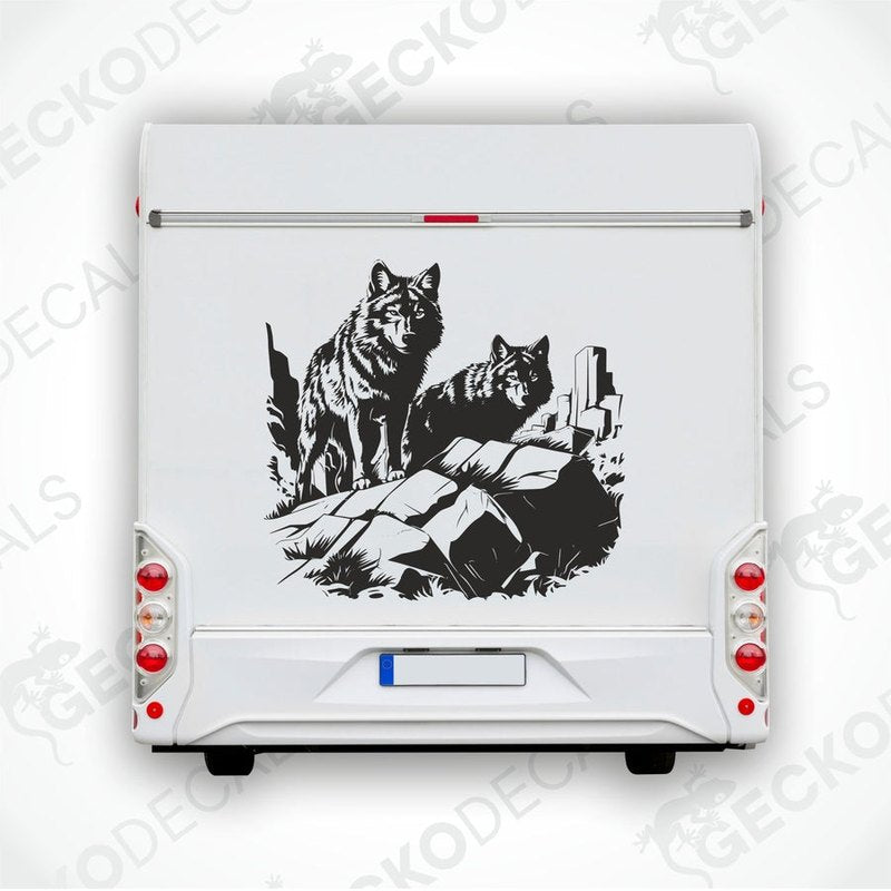 A black and white image of two wolves howling in a forest, applied as a decal on the side of a white vehicle.