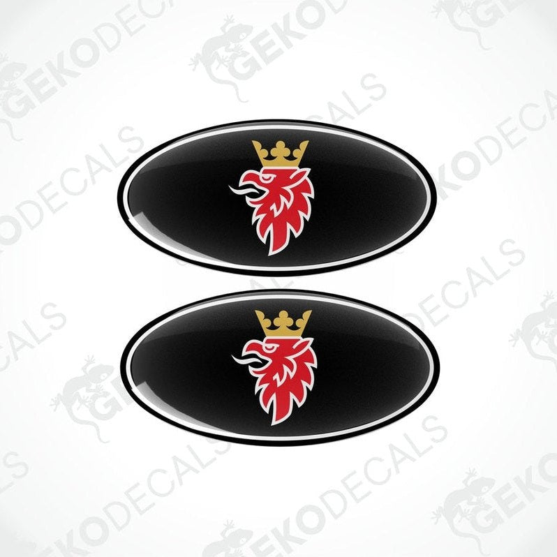 Two black, red, and white car decals with a design that includes a crown and a stylized bird.