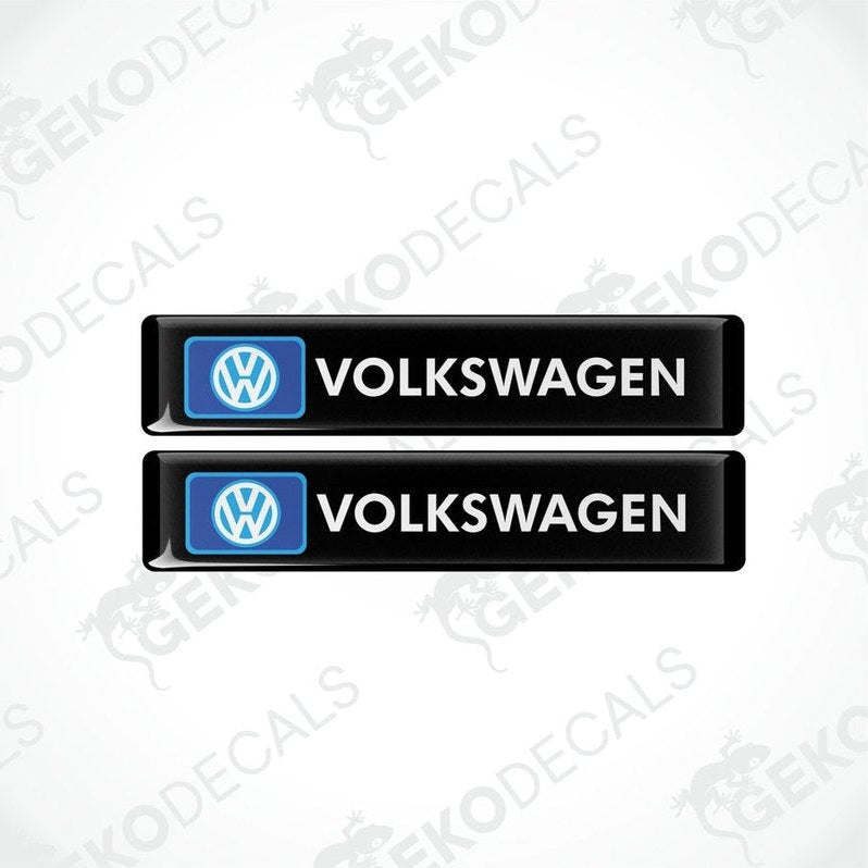Two black rectangular vinyl decals with VOLKSWAGEN.' text and the Volkswagen logo in blue.