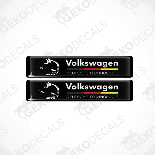 Two rectangular black vinyl decals with 'Volkswagen' and 'DEUTSCHES TECHNOLgie' text in white and red-yellow colors