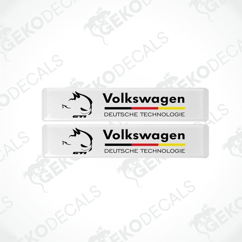 Two rectangular withe vinyl decals with 'Volkswagen' and 'DEUTSCHES TECHNOLgie' text in black and red-yellow colors