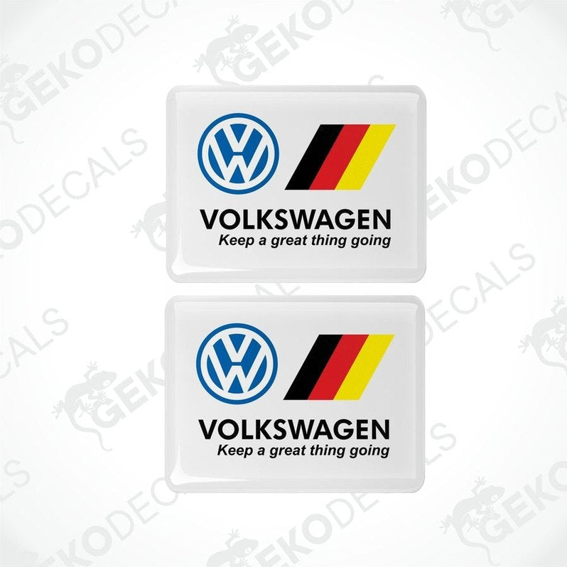 Two withe rectangular vinyl decals with the Volkswagen logo and the phrase 'Keep a great thing going' in black lettering, and a yellow and red stripe.