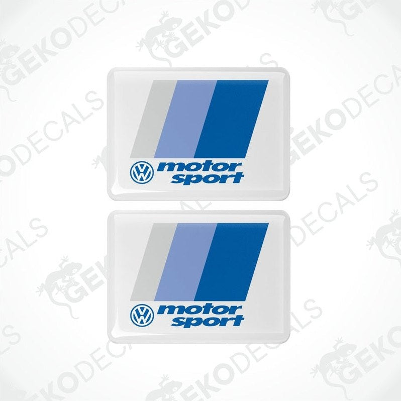 Two withe rectangular vinyl decals with the Volkswagen logo and the phrase motorsport