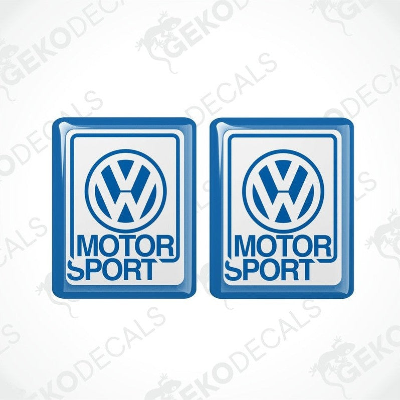 Two blue vinyl stickers with the Volkswagen logo and the word 'MOTORSPORT' printed below.