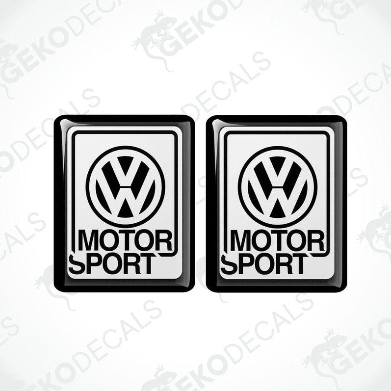 Two black vinyl stickers with the Volkswagen logo and the word 'MOTORSPORT' printed below.