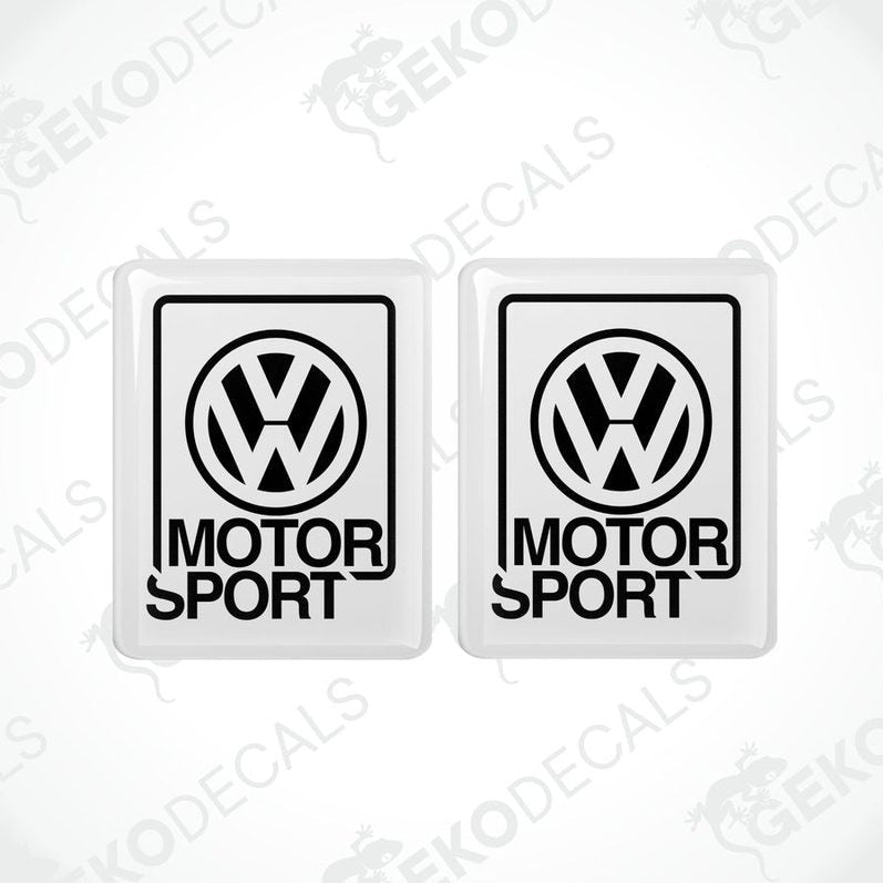 Two withe vinyl stickers with the Volkswagen logo and the word 'MOTORSPORT' printed below.
