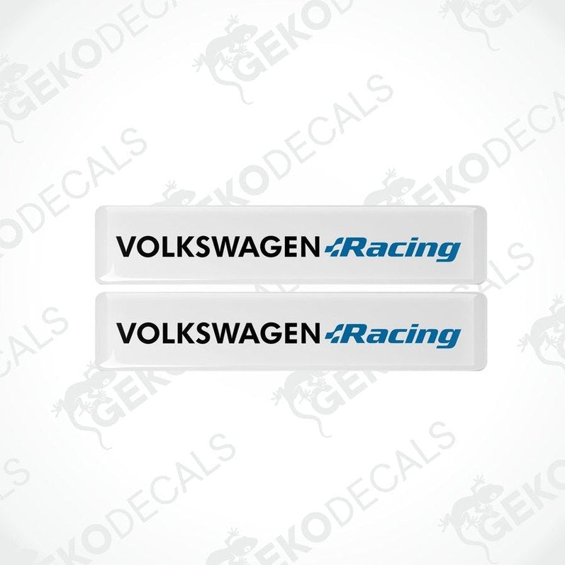 Two withe vinyl stickers with the text 'VOLKSWAGEN RACING' in blue and white colors, placed on a black background.