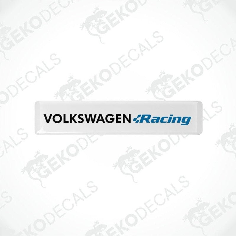Two withe vinyl stickers with the text 'VOLKSWAGEN RACING' in blue and white colors, placed on a black background.