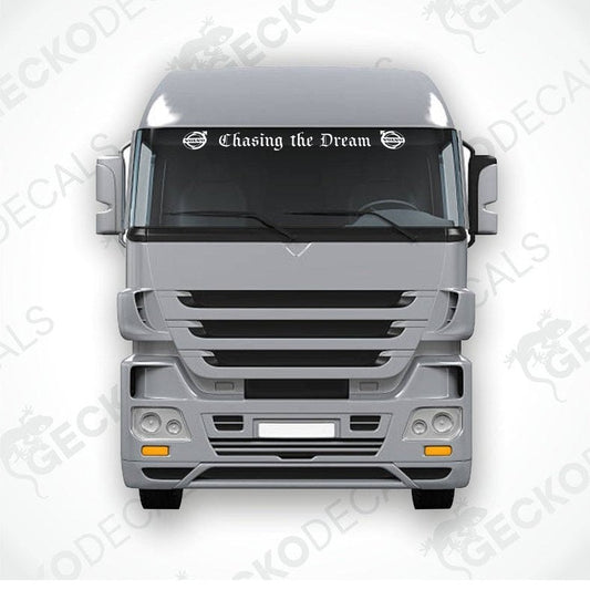 A die cut sticker with the phrase 'Chasing the Dream' displayed on the front windscreen of a gray Volvo truck.