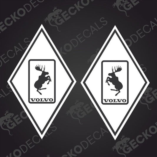 Two diamond-shaped vehicle decals, one with a moose design, the other featuring the Volvo brand logo, both in black, white, and gray colors.