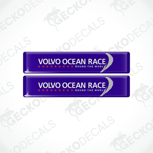 Two blue vinyl stickers with the text 'VOLVO OCEAN RACE ROUND THE WORLD' and a logo consisting of a stylized 'V' in white on a blue background, placed on a white surface.