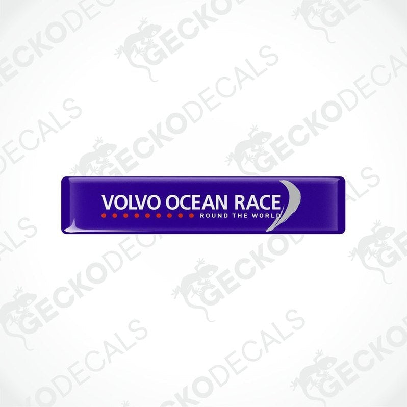 Blue vinyl stickers with the text 'VOLVO OCEAN RACE ROUND THE WORLD' and a logo consisting of a stylized 'V' in white on a blue background, placed on a white surface.