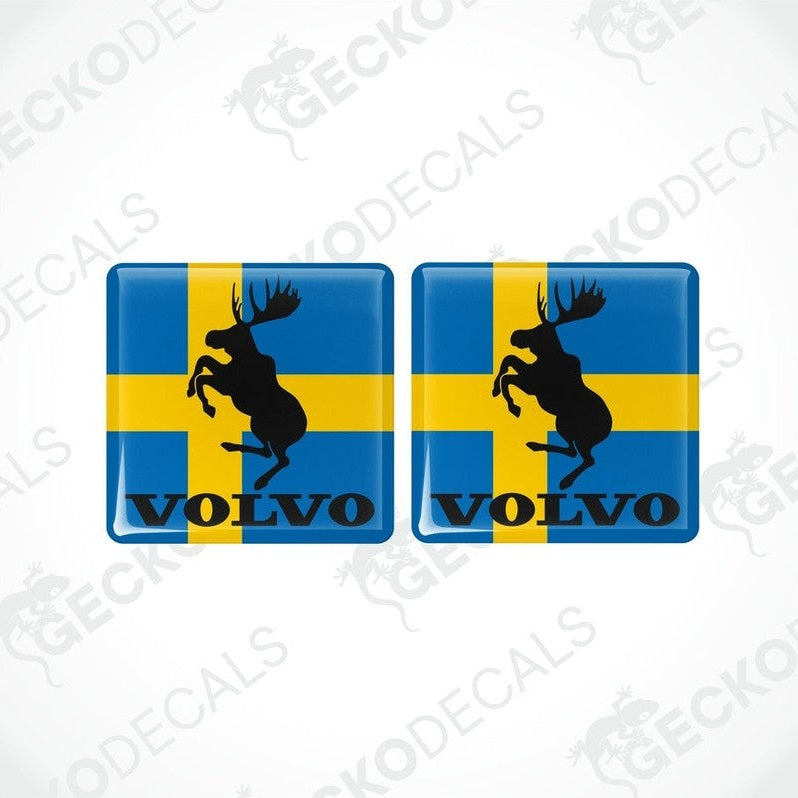 Two blue vinyl stickers with a yellow and black moose design and the Volvo brand logo.