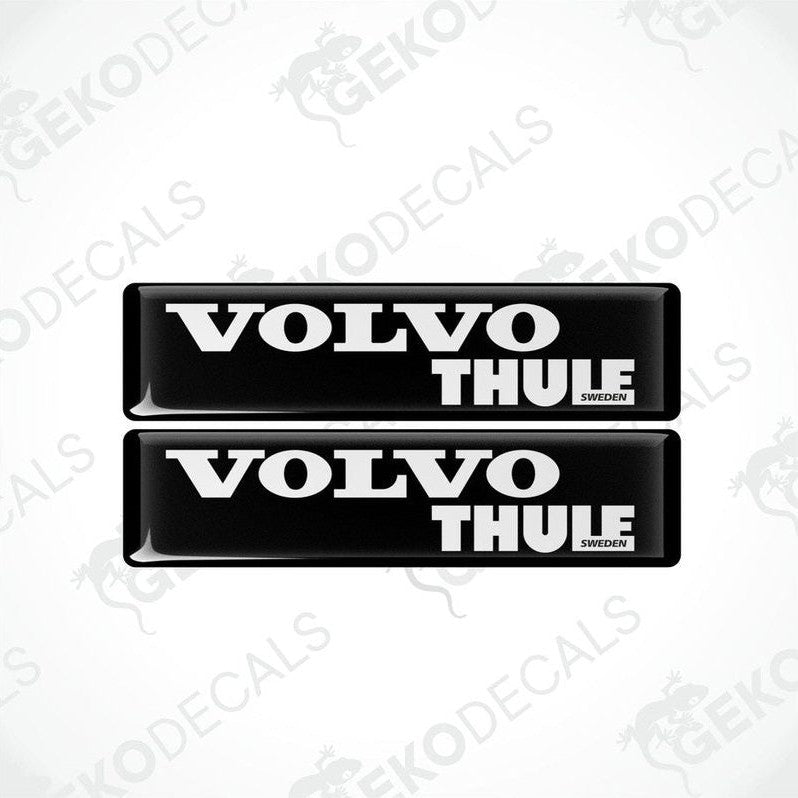 Two black vinyl stickers with the word 'THULE' and the Volvo brand logo in white.