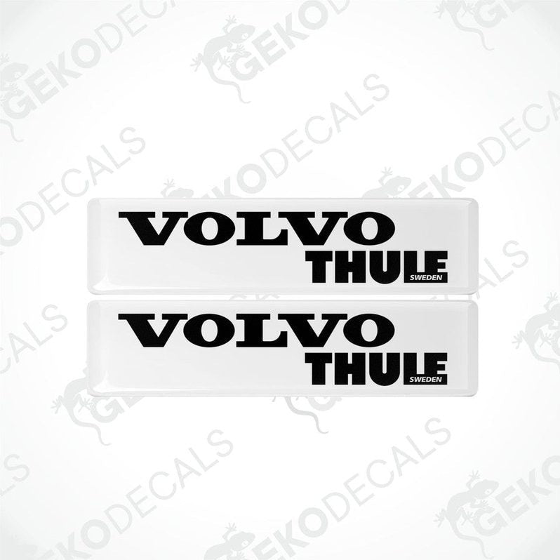 Two withe vinyl stickers with the word 'THULE' and the Volvo brand logo in black.