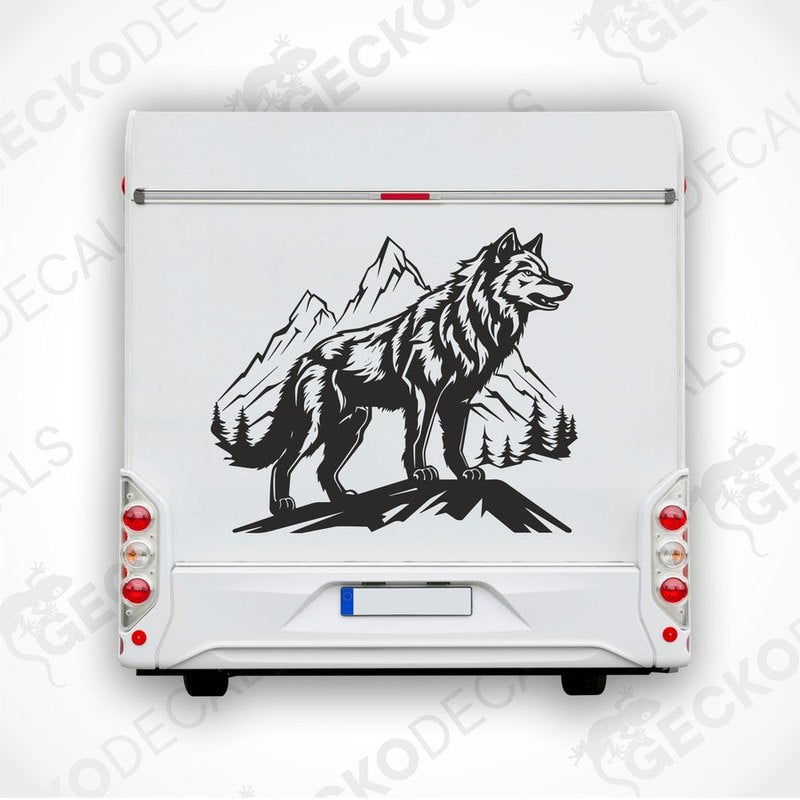 A black and white decal of a wolf in a mountainous landscape, positioned on the side of a white vehicle.