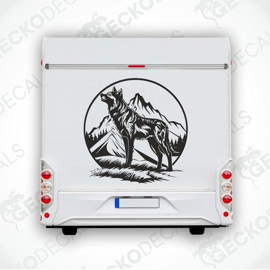 A black decal of a wolf howling with mountains in the background, intended for use on the rear of a vehicle.