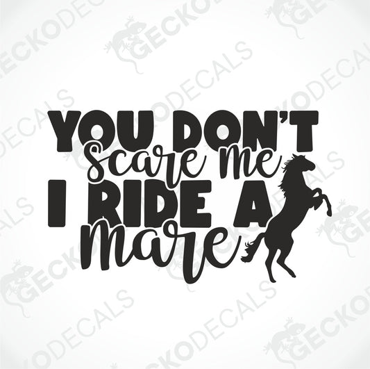 A black and white decal with the text 'YOU DON'T SCARE ME I RIDE A MARE' and a silhouette of a horse below the text.