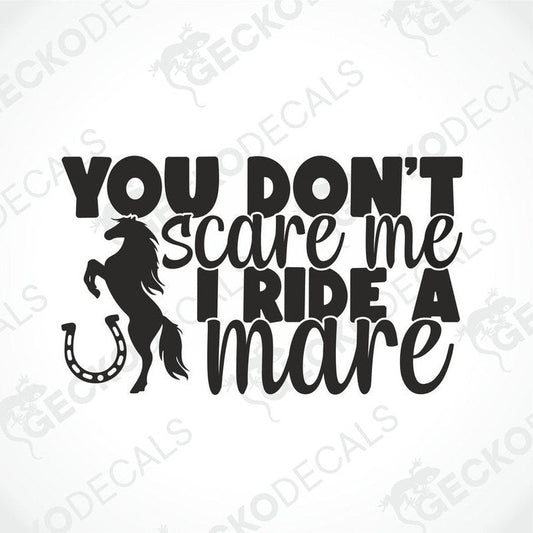 A black decal with white text that reads 'YOU DON'T SCARE ME I RIDE A MARE' with a silhouette of a horse and a horseshoe.