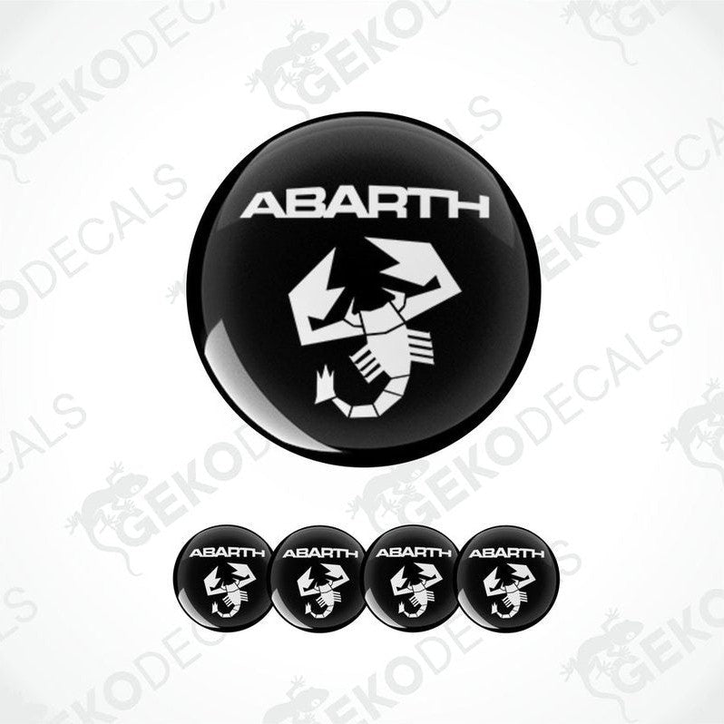 A set of four black and white vinyl stickers with the word 'ABARTH' printed on them.